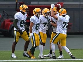 Teammates celebrate Edmonton Elks receiver Earnest Edwards' (73) touchdown during an intra-squad scrimmage in training camp at Commonwealth Stadium in Edmonton, July 25, 2021.