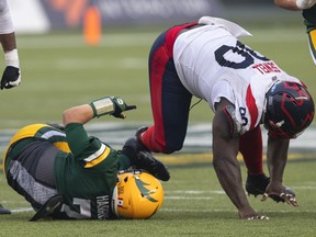 Montreal Alouettes defensive tackle Almondo Sewell (90) sacks Edmonton Elks quarterback Trevor Harris (7) in Edmonton on Saturday, Aug. 14, 2021.