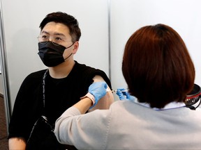 A man receives the Moderna coronavirus vaccine at the Tokyo Metropolitan Government building in Tokyo, June 25, 2021.