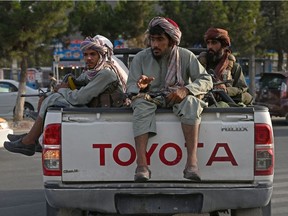 Taliban fighters in a vehicle patrol the streets of Kabul on August 23, 2021 as in the capital, the Taliban have enforced some sense of calm in a city long marred by violent crime, with their armed forces patrolling the streets and manning checkpoints.