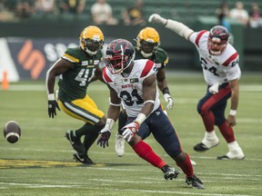 Tevaun Smith (4) of the Edmonton Elks, watches a ball bounce in front of William Stanback (31) of the Montreal Alouettes at Commonwealth Stadium in Edmonton on Aug. 14, 2021.