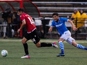FC Edmonton’s Hunter Gorskie (27) chases Calvary FC’s Joseph Di Chiara (14) during the first half of Canadian Premier League action at Clarke Stadium in Edmonton, on Wednesday, Sept. 1, 2021.