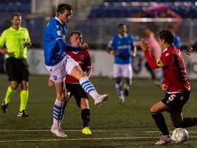 FC Edmonton’s Easton Ongaro (9) shoots past Calvary FC’s Mason Trafford (5) during the second half of Canadian Premier League action at Clarke Stadium in Edmonton, on Wednesday, Sept. 1, 2021.
