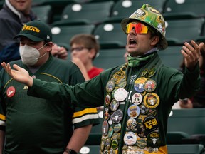 Fans arriving early at Commonwealth Stadium watch the Edmonton Elks warm up before the Labour Day Rematch against the Calgary Stampeders in Edmonton on Saturday, Sept. 11, 2021.