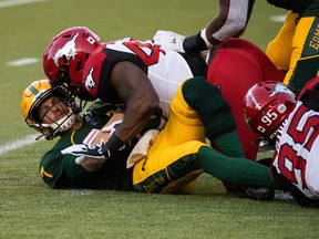 Edmonton Elks quarterback Trevor Harris (7) is sacked by Calgary Stampeders’ Shawn Lemon (40) at Commonwealth Stadium in Edmonton on Saturday, Sept. 11, 2021.