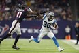 Chuba Hubbard of the Carolina Panthers tries to hold off the tackle of Zach Cunningham of the Houston Texans last week.