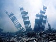 (FILES) In this file photo the rubble of the twin towers of the World Trade Center smoulder following a terrorist attack in lower Manhattan, New York on September 11, 2001. - On the morning of September 11, 2001, New Yorkers woke to crisp blue skies following a storm that had soaked America's northeastern seaboard the day before. A buildup of high pressure had helped push the cold front out into the Atlantic, creating a weather phenomenon known in aviation parlance as "severe clear." The cloudless sky was little portent of the dark, history-changing day that was about to unfold. (Photo by Alexandre FUCHS / AFP) (Photo by ALEXANDRE FUCHS/AFP via Getty Images)