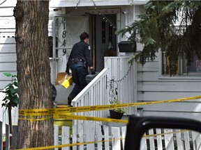 Yellow tape surrounds a house on 79 St. near 119 Ave. as police investigate an incident in Edmonton, August 24, 2021.