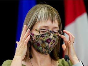 Dr. Deena Hinshaw, Alberta chief medical officer of health, takes off her face mask at a news conference on the province's COVID-19 situation on Friday Sept. 3, 2021 in Edmonton.