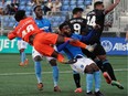 FC Edmonton goalkeeper Darlington Murasiranwa and team mates Mele Temguia and Allan Zebie defend against Pacific FC Alejandro Diaz and Terran Campbell during Canadian Premier League soccer game action in Edmonton on Saturday September 4, 2021.