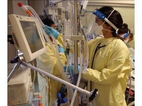 Teams in a crowded Calgary ICU work on a patient on a ventilator. Photo supplied by AHS