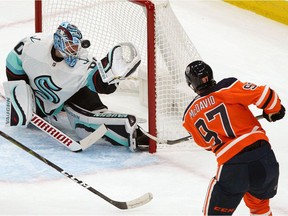 Seattle Kraken goalie Chris Driedger makes a save on Edmonton Oilers captain Connor McDavid during first period National Hockey League pre-season game action in Edmonton on Tuesday September 28, 2021.