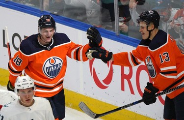 Edmonton Oiler Zach Hyman (left) celebrates his goal with team mate Jesse Puljujarvi (right) during first period National Hockey League pre-season game action against the Seattle Kraken in Edmonton on Tuesday September 28, 2021.