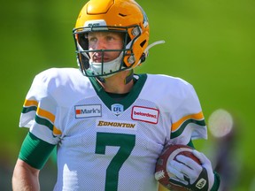 Edmonton Elks quarterback Trevor Harris runs off the field with the football after scoring a touchdown against the Calgary Stampeders in Calgary on Monday, Sept. 6, 2021.