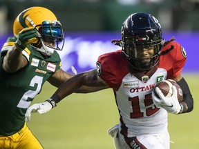 Ottawa Redblacks ball-carrier Ryan Davis (15) is chased by Edmonton Elks cornerback Jonathon Mincy (2) in Edmonton on Aug. 7, 2021. Ottawa won 16-12.