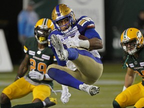 Winnipeg Blue Bombers running back Andrew Harris makes a leaping reception during a Canadian Football League game against the Edmonton Elks in Edmonton on Aug. 23, 2019.