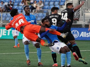 FC Edmonton goalkeeper Darlington Murasiranwa and team mates Mele Temguia and Allan Zebie defend against Pacific FC Alejandro Diaz and Terran Campbell during Canadian Premier League soccer game action in Edmonton on Saturday September 4, 2021.