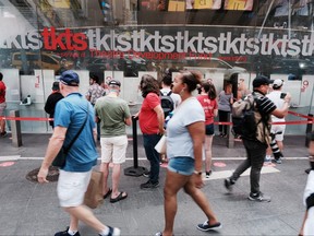 People purchase tickets at the reopened TKTS booth for Broadway shows in Times Square on Sept. 14, 2021 in New York City.