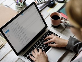 Businesswoman Checking E-mail Online on Laptop