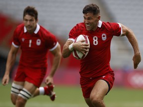 Justin Douglas of Canada runs through to score a try against the United States at the Tokyo Olympics on July 28, 2021.