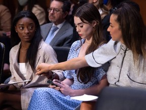 US Olympic gymnasts Simone Biles, left, McKayla Maroney, centre, and Aly Raisman, right, arrive to testify during a U.S. Senate Judiciary hearing about the Inspector General's report on the FBI handling of the Larry Nassar investigation of sexual abuse of Olympic gymnasts, on Capitol Hill, in Washington, D.C., Wednesday, Sept. 15, 2021.