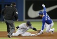 New York Yankee Gleyber Torres #25 of the New York Yankees misses the tag on the Jays' Corey Dickerson at Rogers Centre on Thursday. Getty Images