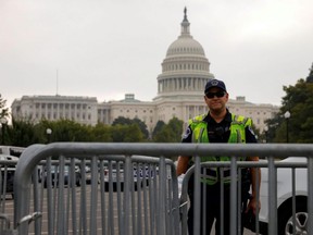 A U.S. Capitol police officer stands guard in front of the Capitol building on the day that supporters of defendants being prosecuted in the Jan 6 attack on the Capitol will hold a rally in Washington, D.C., Saturday, Sept. 18, 2021.