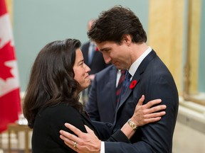 In this file photo taken on Nov. 4, 2015, Prime Minister Justin Trudeau speaks with Minister of Justice Jody Wilson-Raybould during a swearing-in ceremony at Rideau Hall in Ottawa.