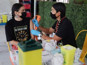 Social media influencer Kendra Jessie received her first dose of the COVID-19 vaccine with Dr. James Makokis at the VaxxFest event at the Grey Eagle Casino on Saturday, September 25, 2021. VaxxFest is a festival-style event which will encourage Indigenous youth to get the COVID-19 vaccine.