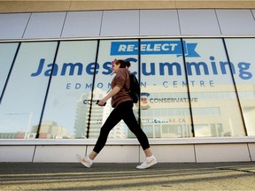 A pedestrian makes their way past Edmonton Centre Conservative candidate James Cumming's campaign office, Monday Sept. 20, 2021. Photo by David Bloom