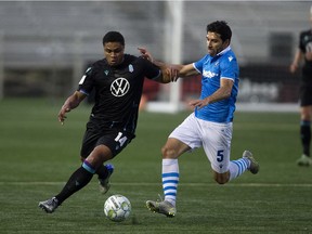 FC Edmonton's Ramon Soria (5) battles the Pacific FC's Terran Campbell (14) during Canadian Premier League action at Clarke Stadium in Edmonton, Tuesday Sept. 14, 2021.