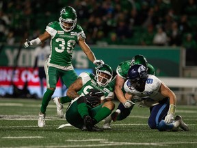 Saskatchewan Roughriders defensive lineman Keion Adams picks up a fumble from Toronto Argonauts quarterback Nick Arbuckle during a CFL football game at Mosaic Stadium in Regina, Saskatchewan on Sept. 17, 2021.