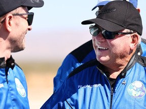Star Trek actor William Shatner, right, smiles as Planet Labs co-founder Chris Boshuizen looks on during a media availability on the landing pad of Blue Origin's New Shepard after they flew into space on Oct. 13, 2021. near Van Horn, Texas. Shatner became the oldest person to fly into space on the 10-minute flight. They flew aboard mission NS-18, the second human spaceflight for the company which is owned by Amazon founder Jeff Bezos.