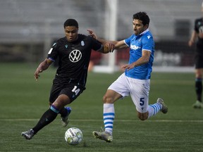 FC Edmonton's Ramon Soria (5) battles the Pacific FC's Terran Campbell (14) during Canadian Premier League action at Clarke Stadium in Edmonton, Tuesday Sept. 14, 2021.