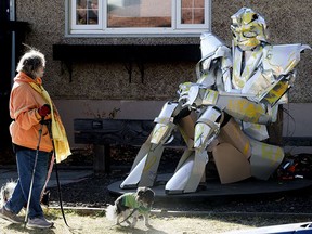 A pedestrian walks past a piece by artist Johnathan Onyschuk outside the Lowlands Project Space, 11208 65 St., in Edmonton Tuesday Oct. 12, 2021. Photo by David Bloom