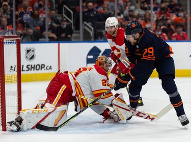 Edmonton Oilers’ Leon Draisaitl (29) is stopped by Calgary Flames goaltender Jacob Markstrom (25) during first period NHL action at Rogers Place in Edmonton, on Saturday, Oct. 16, 2021.