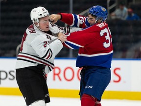Edmonton Oil Kings’ Shea Van Olm (39) fights Red Deer Rebels’ Joel Sexsmith (27) during second period WHL action at Rogers Place in Edmonton, on Sunday, Oct. 17, 2021.
