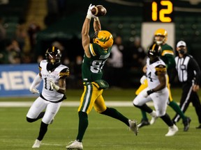 Edmonton Elks’ Greg Ellingson (82) fumbles a pass from quarterback Taylor Cornelius (15) against the Hamilton Tiger-Cats during first half CFL action at Commonwealth Stadium in Edmonton, on Friday, Oct. 29, 2021.