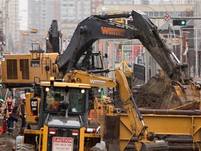 A construction crew works on the Jasper Avenue New Vision project in Edmonton, on Wednesday, March 24, 2021.