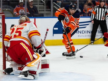 Edmonton Oilers' Leon Draisaitl (29) shoots on Calgary Flames' goaltender Jacob Markstrom (25) during first period preseason NHL action at Rogers Place in Edmonton, on Monday, Oct. 4, 2021.
