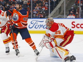 Edmonton Oilers forward Brendan Perlini (42) looks for a puck in front of Calgary Flames goaltender Jacob Markstrom (25) during the first period at Rogers Place.