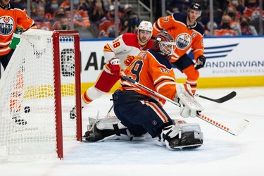 Calgary Flames' Elias Lindholm (28) scores a goal on Edmonton Oilers' goaltender Mikko Koskinen (19) during second period preseason NHL action at Rogers Place in Edmonton, on Monday, Oct. 4, 2021.