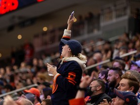 Edmonton Oilers fans cheer Connor McDavid's goal on Calgary Flames' goaltender Jacob Markstrom (25) during third period preseason NHL action at Rogers Place in Edmonton, on Monday, Oct. 4, 2021.