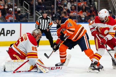 Edmonton Oilers' Zach Hyman (18) shoots at Calgary Flames' goaltender Jacob Markstrom (25) during third period preseason NHL action at Rogers Place in Edmonton, on Monday, Oct. 4, 2021.