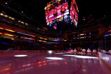 The Edmonton Oilers and the Calgary Flames are seen during the singing of the national anthem before the first period of a preseason NHL game at Rogers Place in Edmonton, on Monday, Oct. 4, 2021.