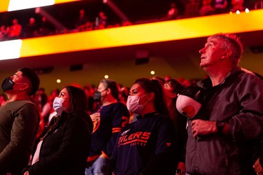 Edmonton Oilers fans sing the national anthem before the first period of a preseason NHL game versus the Calgary Flames at Rogers Place in Edmonton, on Monday, Oct. 4, 2021.