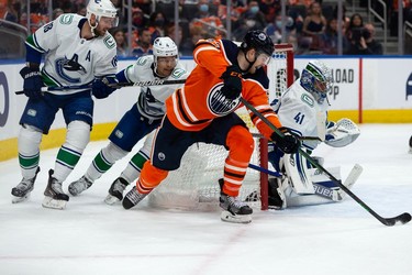 Edmonton Oilers' Warren Foegele (37) shoots on Vancouver Canucks' Jaroslav Halak (41) during the first period of preseason NHL action at Rogers Place in Edmonton, on Thursday, Oct. 7, 2021. Photo by Ian Kucerak