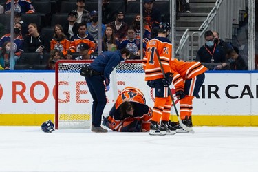 Edmonton Oilers' goaltender Mike Smith (41) is assisted by medical staff after a crash with Vancouver Canucks Vasily Podkolzin (92) during the first period of preseason NHL action at Rogers Place in Edmonton, on Thursday, Oct. 7, 2021. Photo by Ian Kucerak