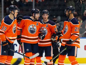 Edmonton Oilers' Leon Draisaitl (29) celebrates a goal with teammates on Vancouver Canucks' Jaroslav Halak (41) during the first period of preseason NHL action at Rogers Place in Edmonton, on Thursday, Oct. 7, 2021.