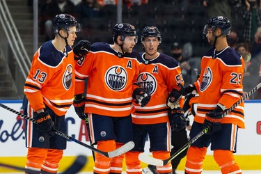 Edmonton Oilers' Leon Draisaitl (29) celebrates a goal with teammates on Vancouver Canucks' Jaroslav Halak (41) during the first period of preseason NHL action at Rogers Place in Edmonton, on Thursday, Oct. 7, 2021. Photo by Ian Kucerak